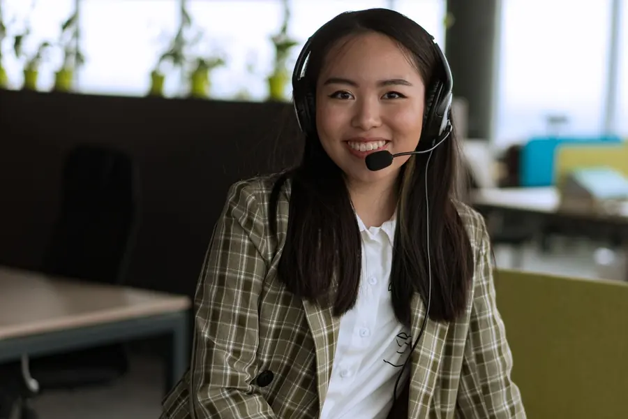 Atendente com headset sorrindo durante atendimento